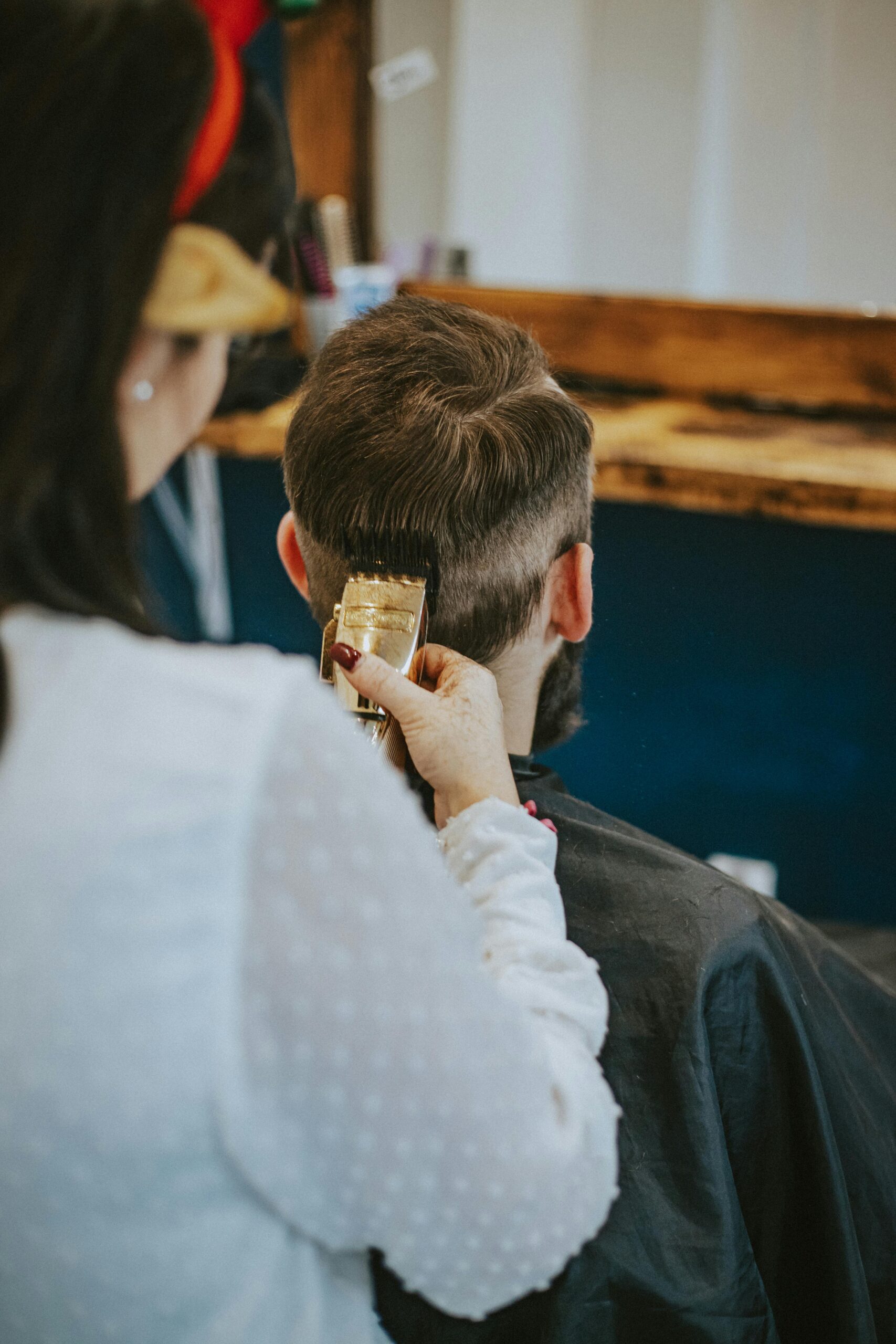 a man getting his hair trimmed by a trimmer machine